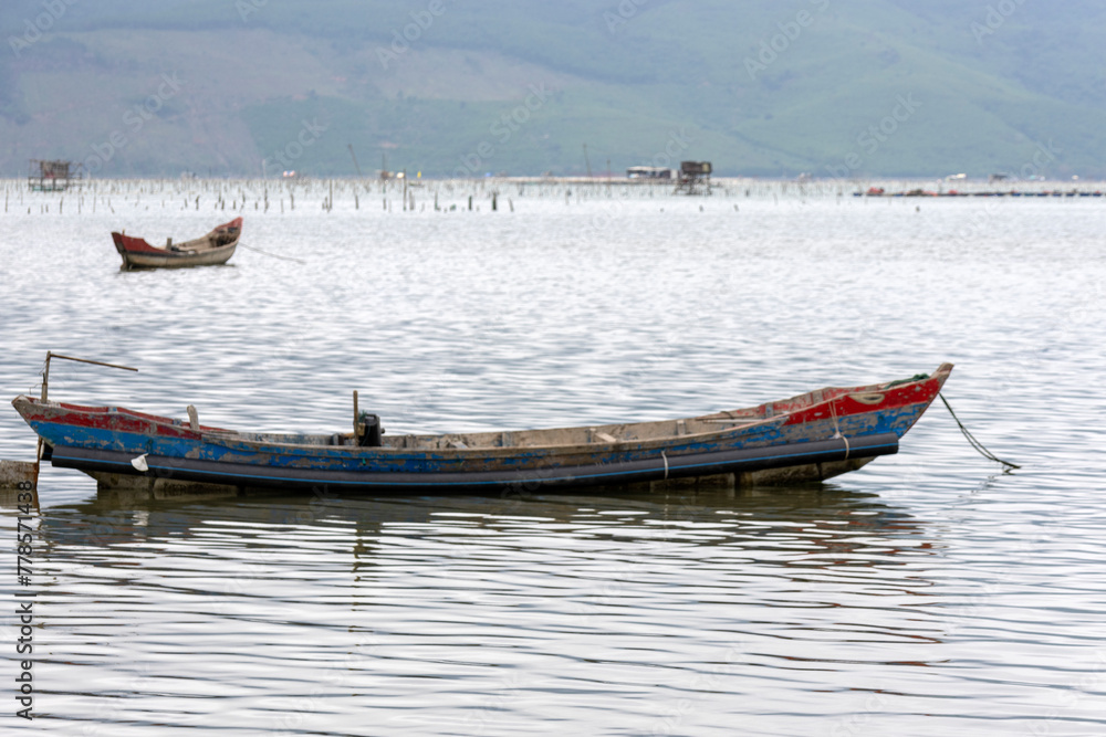 Traditional fishing boat in oyster farming industry in Lap An Lagoon, Vietnam