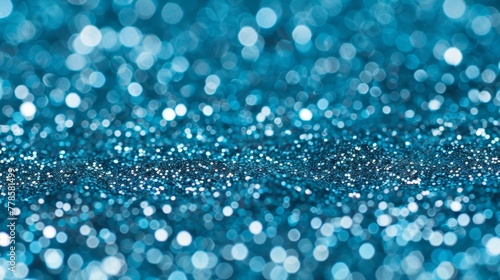 Detailed view of a vibrant blue glitter background with shimmering sapphire particles creating a sparkly bokeh effect