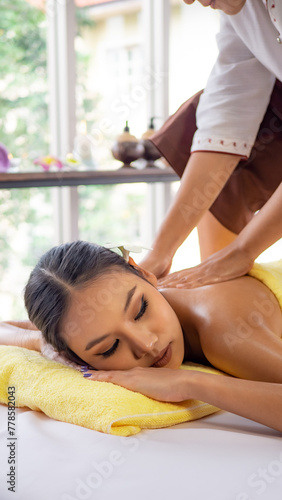 Young Thai woman relaxes with massage in spa