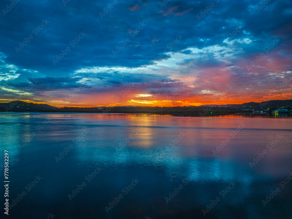 Dawn over the bay water with clouds and reflections Dawn over the bay water with clouds and reflections