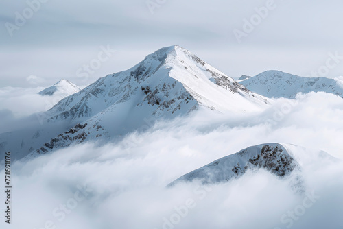 Majestic View of a Snowy Mountain Peak Piercing the Clouds: Showcasing the Beauty and Grandeur of Nature