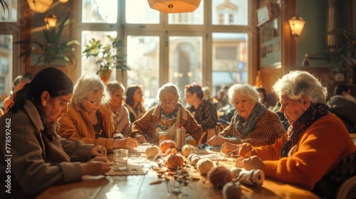 A group of elderly women are sitting around a table, knitting and chatting