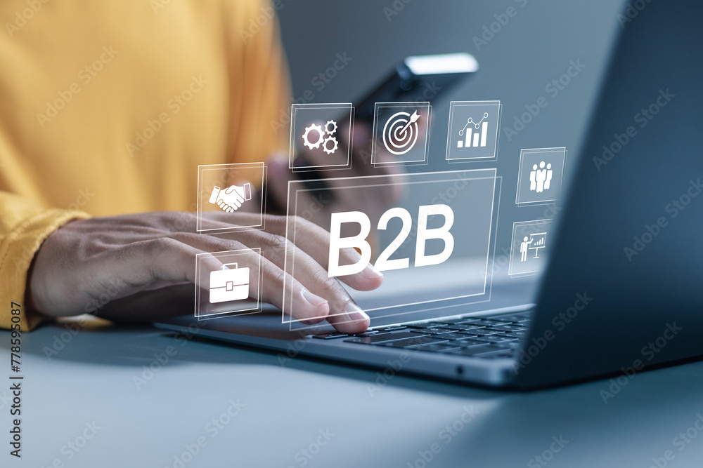 Fototapeta premium B2B marketing concept, business to business, e-commerce, businessman use laptop with B2B icons for professional business and commerce collaboration. business action plan strategy.