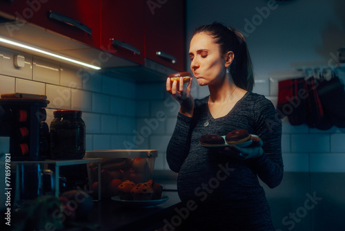 Pregnant Woman Not In the Mood to Eat a Doughnut. Preggy lady disliking the taste and smell of delicious foods 
 photo