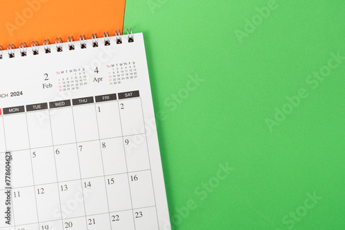 close up of calendar on the green table background, planning for business meeting or travel planning concept