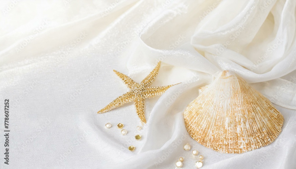 An elegant background of white cloth, seashells and starfish inspired by the sea. An elegant background of white cloth, seashells and starfish inspired by the sea.