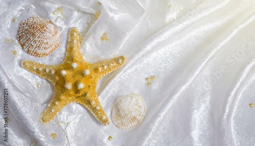 An elegant background of white cloth, seashells and starfish inspired by the sea. photo