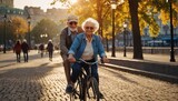 Happy senior couple riding bicycles in spanking on the embankment