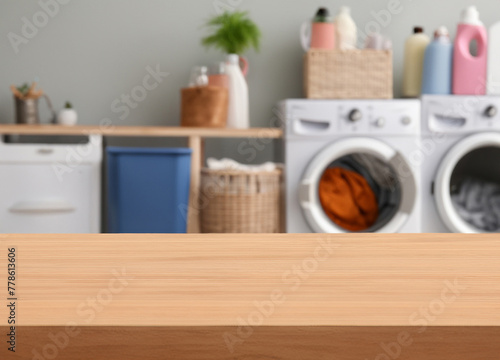 Wood table for display products on blurred laundry room