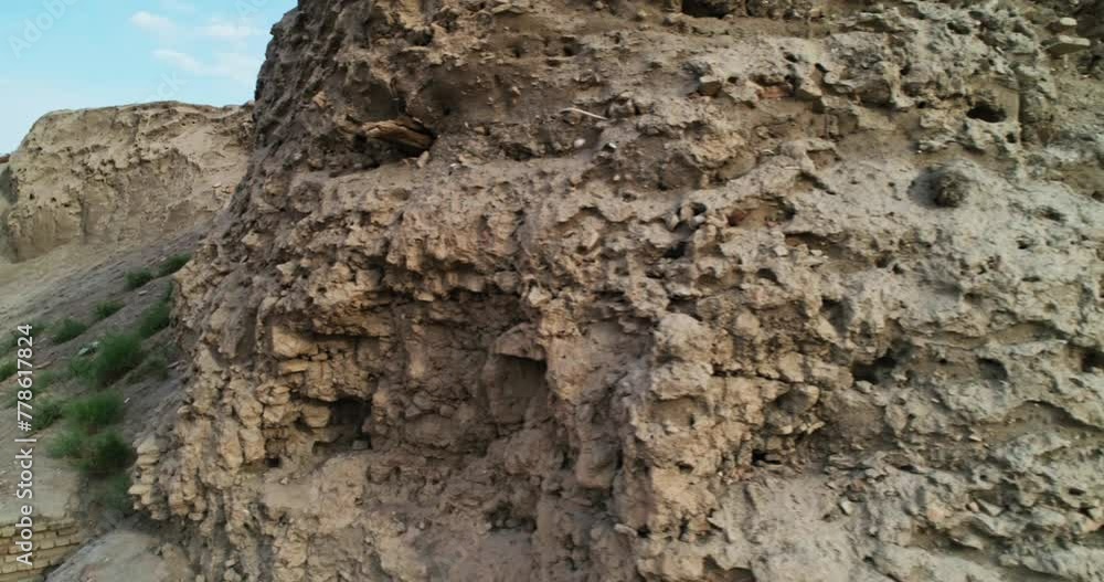 Brick walls of the ancient Ark fortress complex surrounded by old houses in Bukhara, Uzbekistan. Cloudy morning. Brick walls of the ancient Ark fortress complex surrounded by old houses in Bukhara, Uzbekistan. Cloudy morning.