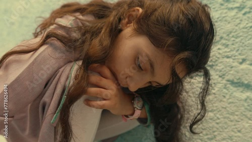 Closeup shot of a Girl in an alley Drawing with Chalk photo