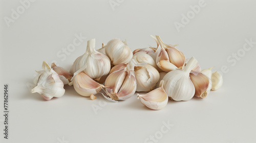Garlic cloves cluster on white surface. Whole and peeled cloves showcased. Design for potent flavor, essential culinary arts symbol. 