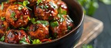 elicious Meatball Dish for Any Occasion. A pan filled with delicious meatballs covered in savory sauce and garnished with fresh basil. Perfect for a hearty meal or Italian-inspired dishes