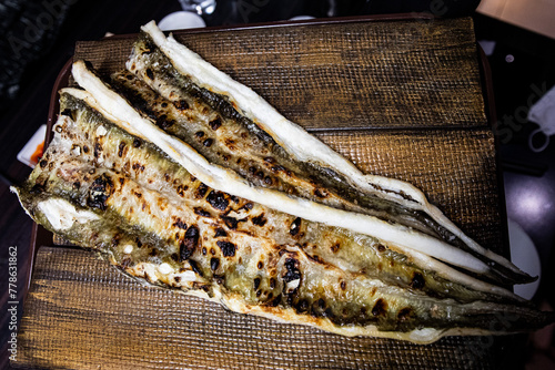 Delicious and healthy grilled eel cooked on an iron plate until yellow.