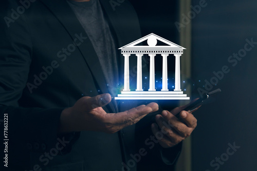 Businessman holding word bank in hand Digital investment, money trade in the global application.