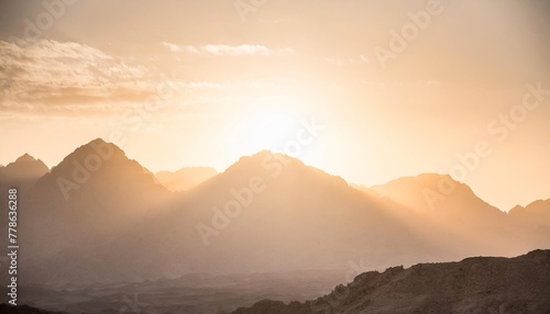 epic sunset landscape sky with big bright sun going behind the mountains in egypt photo