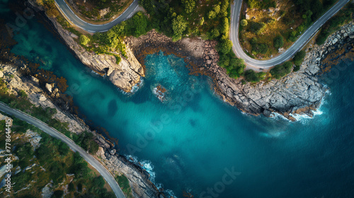 Aerial view of road, rocky sea coast with waves and stones at sunset in Lofoten Islands, Norway. Landscape with beautiful road, transparent blue water, rocks. Top view from drone of highway in summer.