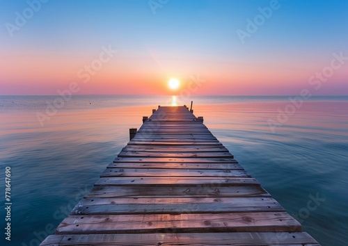 Serene Sunrise over Calm Sea with Wooden Pier Leading into Horizon © Qstock