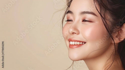 Portrait of a joyful Asian woman with glowing skin, showcasing the results of her natural skincare routine. Space for text on the side.