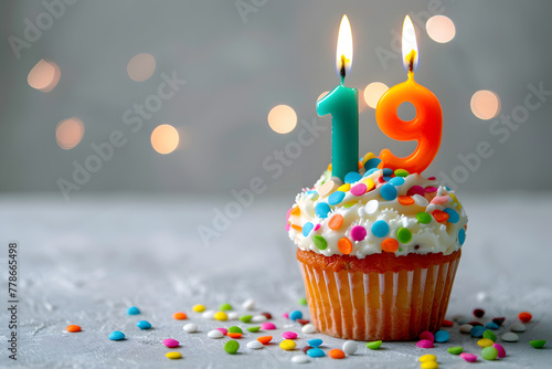 Birthday cupcake with number nineteen candle photo