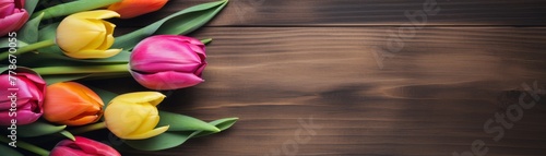 Mixed tulips wrapped in brown paper on rustic wooden background #778670055