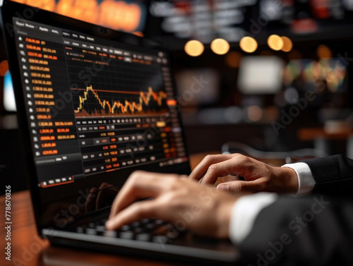 person typing on a laptop Businessman Engaged in Stock Market Trading While Typing