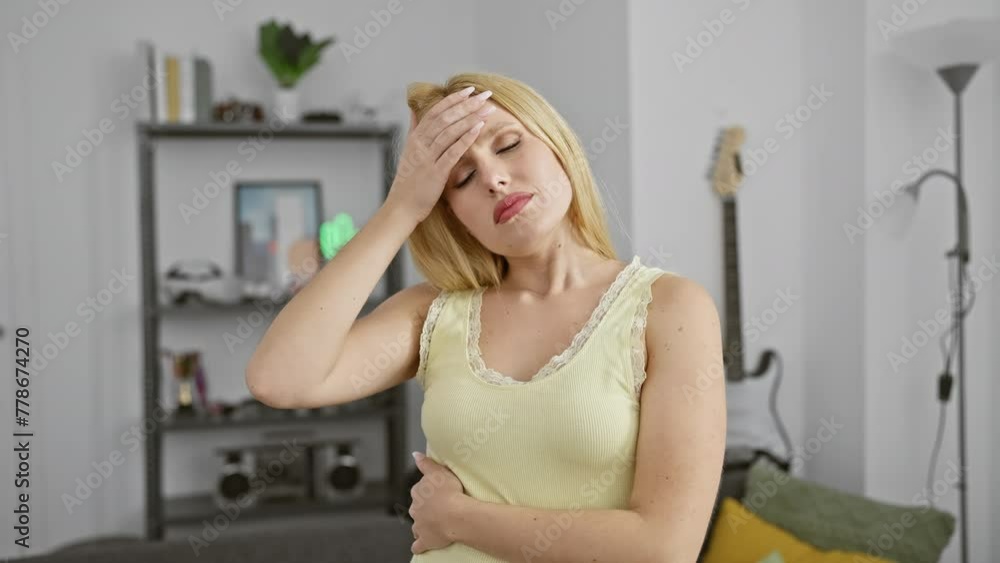 Blonde woman headaches stress living room couch indoors casual Blonde woman headaches stress living room couch indoors casual