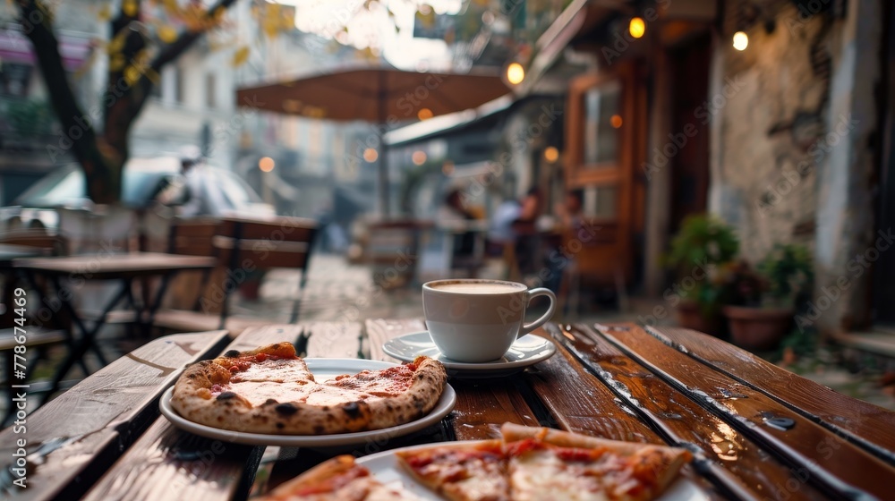 Cup of coffee and slices of pizza on wooden table at outdoor cafe 