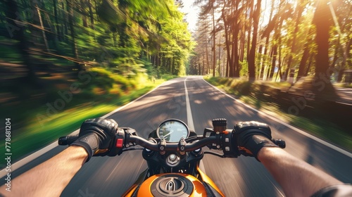 Rider speed down forest - lined road on sports motorbike