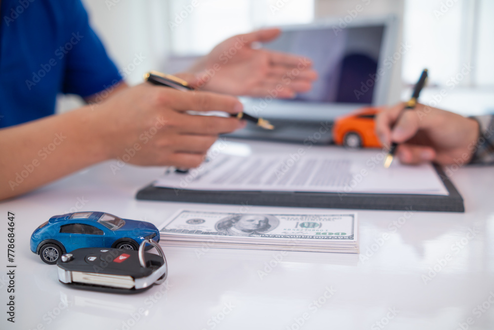 Fototapeta premium Car dealers recommend car to customers before entering into sales contracts so that customers can get the car they like before paying contract money. Concept of making sales contract with distributor