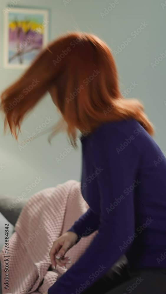 Redhead woman comes to sit on comfortable sofa thinking about life. Pensive housewife rests in living room after routine chores closeup slow motion Redhead woman comes to sit on comfortable sofa thinking about life. Pensive housewife rests in living room after routine chores closeup slow motion