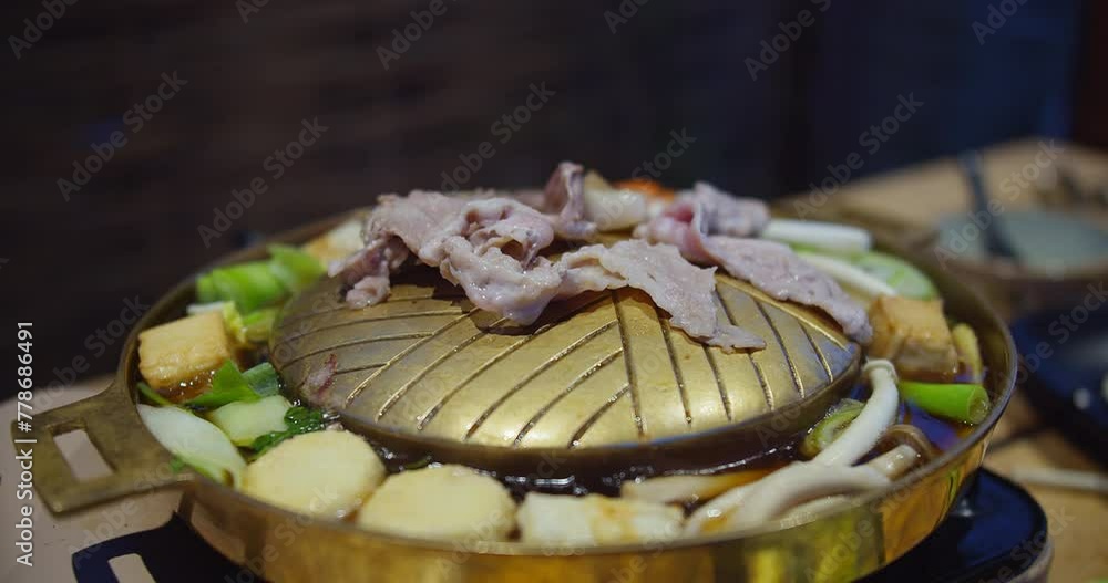 A plate of food with meat and vegetables on top of a grill. The food looks delicious and appetizing A plate of food with meat and vegetables on top of a grill. The food looks delicious and appetizing