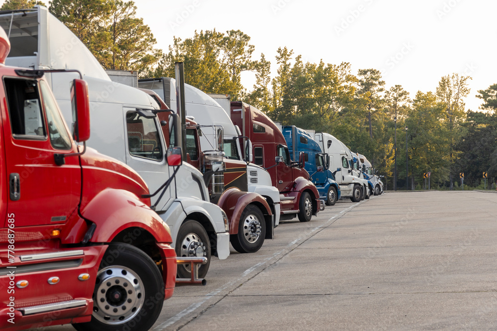 Row of Colorful Semi Trucks Parked in a Row at a Highway Rest Area ...