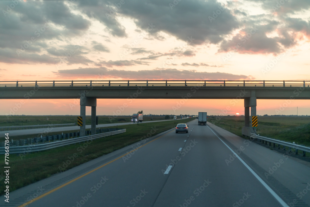 Sundown Over Highway with Overpass and Travelers Embarking on Journeys