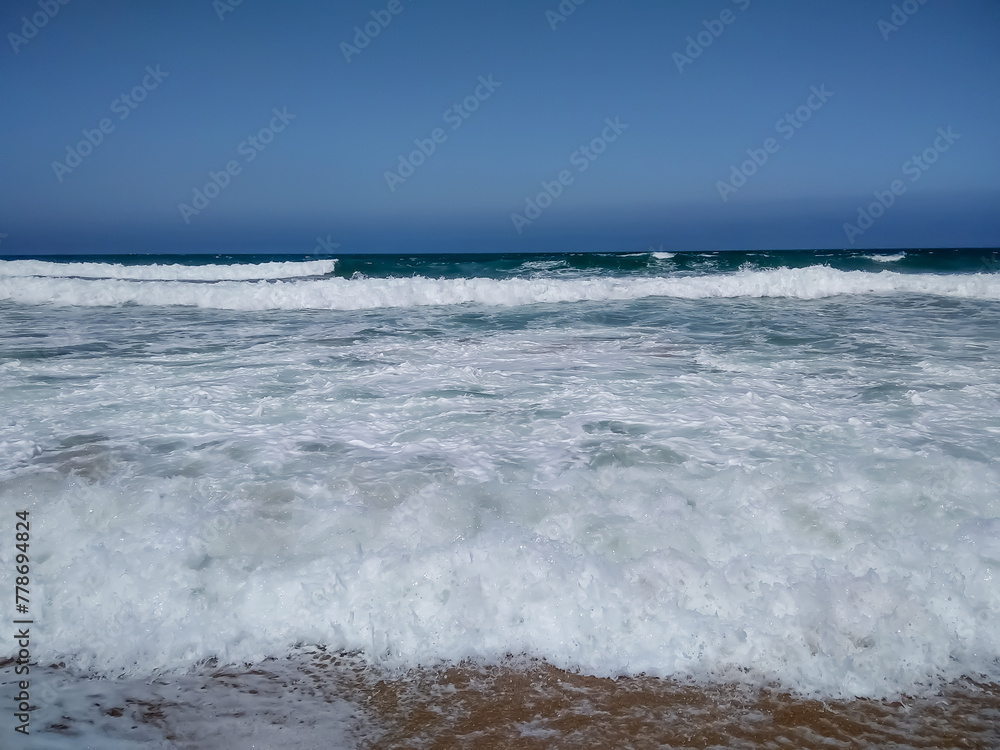 Fototapeta premium Coast of Portugal. One of the beaches in Cascais with crystal clear water. A great place for water sports - surfing.