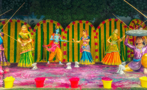Bild auf Leinwand figurine of lord krishna and radha playing holi in village