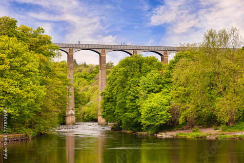 Pontcysyllte Aqueduct,  reflecting in the River Dee, with people walking across, near Llangollen, County Borough of Wrexham, Wales, UK photo