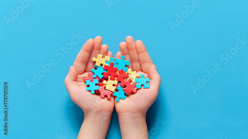 Child's hands cradling a heart-shaped puzzle, symbolizing autism awareness