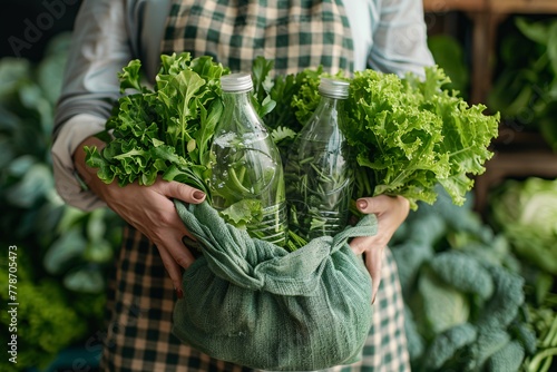 A woman's hands grasp a sustainable bag of leafy greens and a refillable water container, embodying a zero-waste, environmentally-friendly lifestyle.
