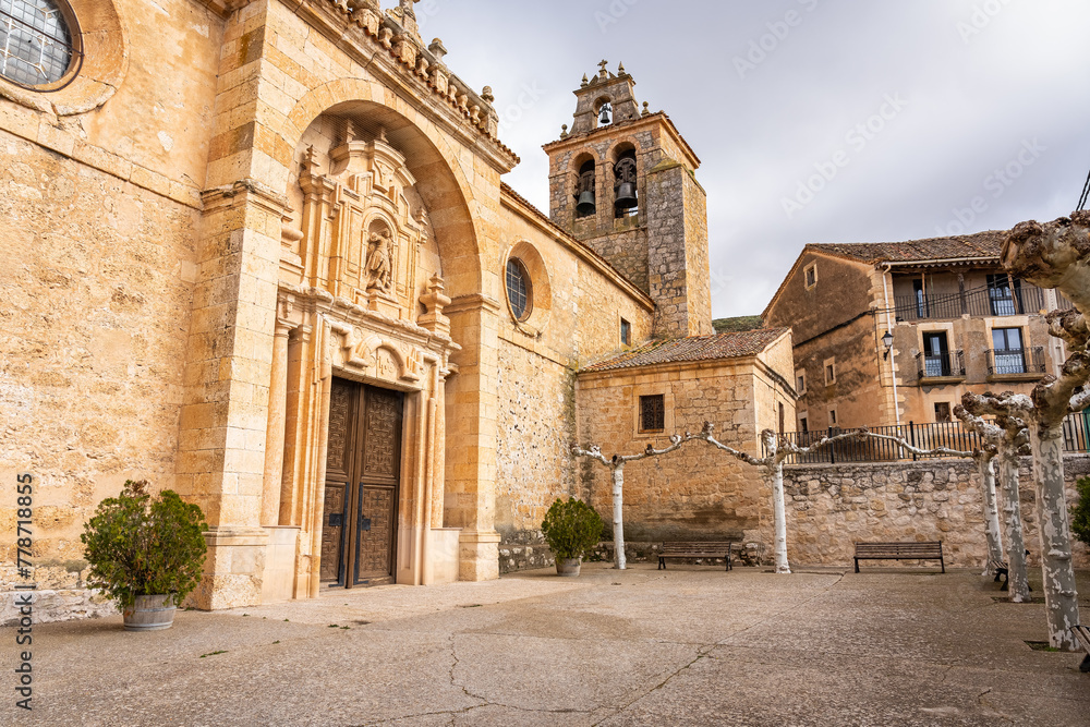 Medieval church facade with tower and bell tower in the old villages of Castilla Leon.