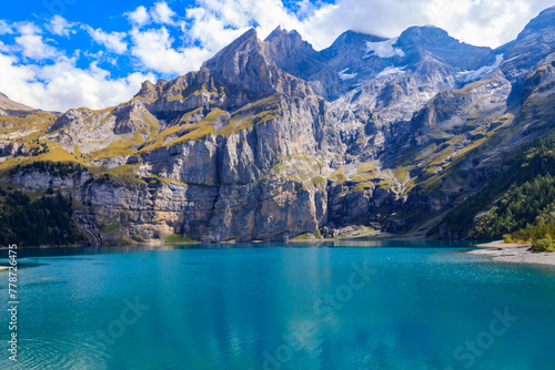 View of Oeschinen lake (Oeschinensee) and Swiss Alps near Kandersteg in Bernese Oberland, Switzerland photo