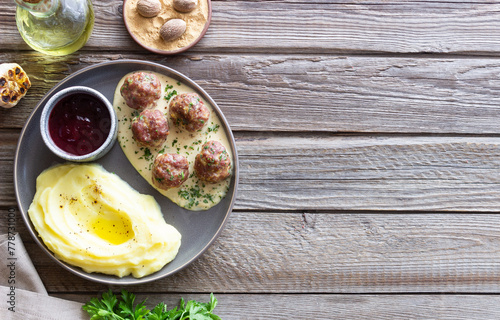 Swedish meatballs in cream sauce, potatoes and lingonberry sauce. Swedish cuisine. Recipe.