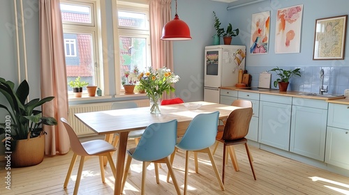 Interior design of a small stylish compact kitchen in an apartment in pastel shades of blue palette, with table and chears