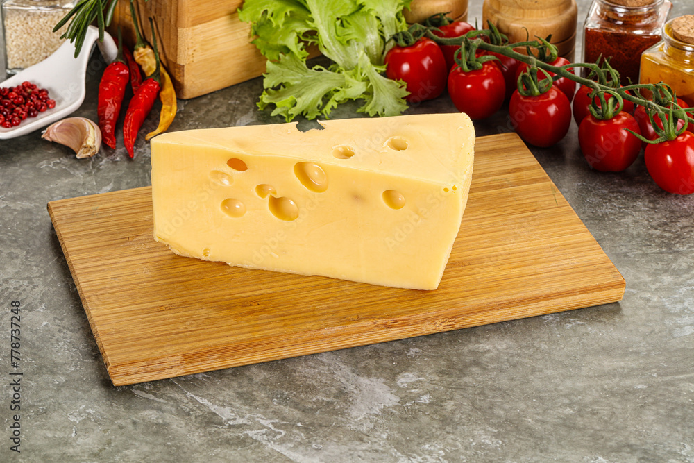 Swiss Maasdam cheese triangle over board Swiss Maasdam cheese triangle over board