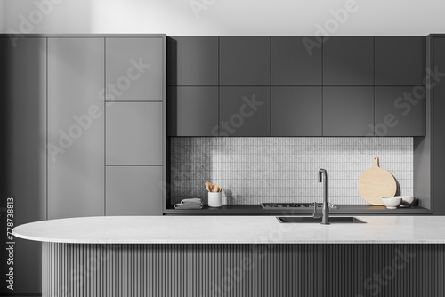 Gray island in white and gray kitchen interior