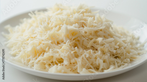 Shredded crab meat mound on white plate. Delicate texture, light sweet flavor for luxurious ravioli filling. Design for premium quality seafood concept. 