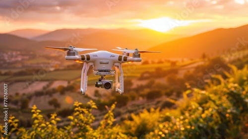 A high-tech drone hovers against a breathtaking sunset, capturing the beauty of the sprawling landscape below.
 photo