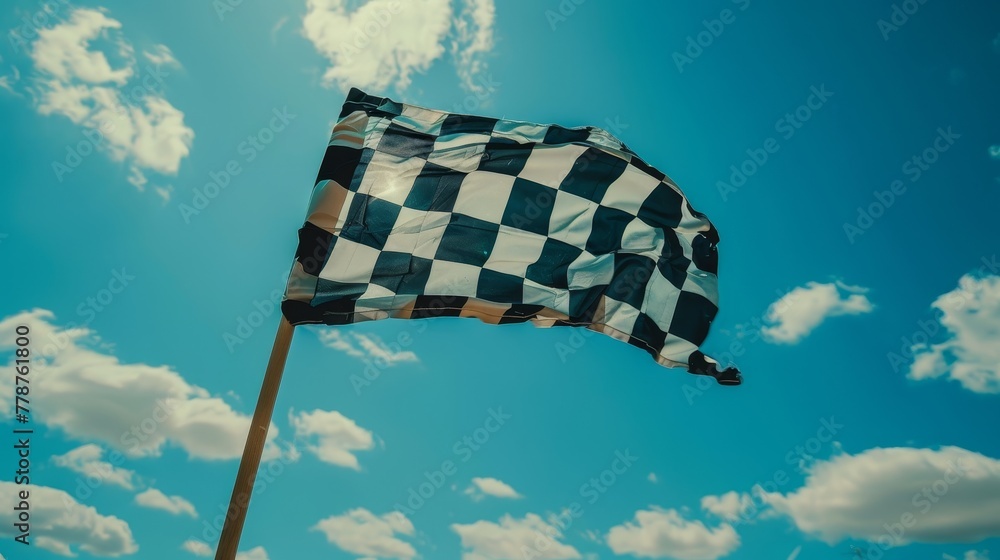 Waving checkered flag against blue sky background. 