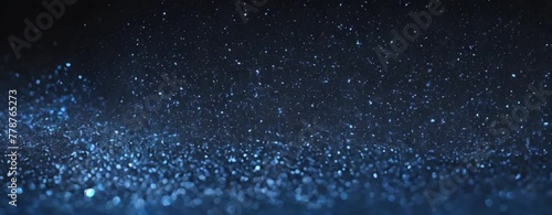 Blue glitter sparks and particles bokeh explosion on plain black background from Generative AI photo