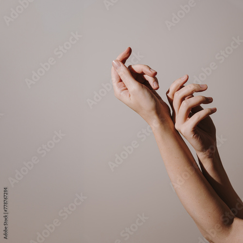 Elegant female hands over white background © Floral Deco